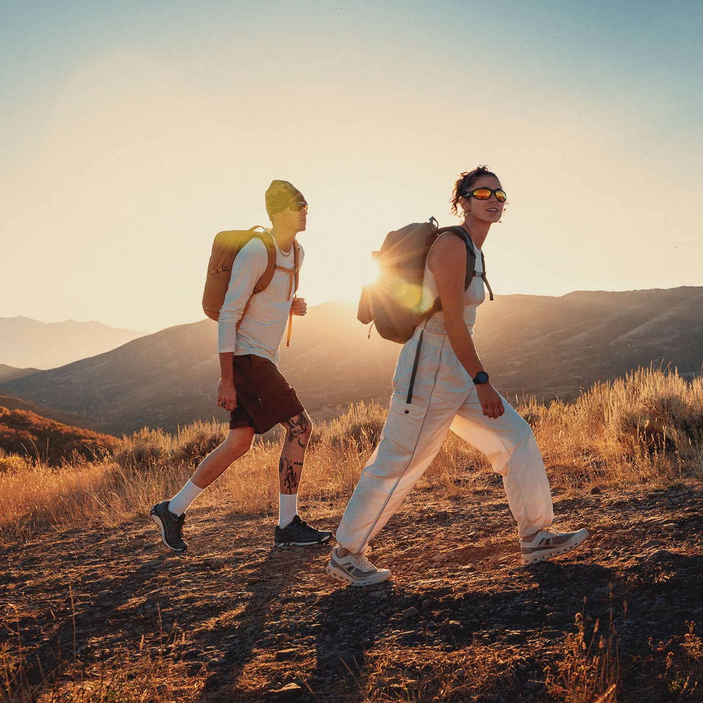 Two hikers wearing their Terros packs on a trail.