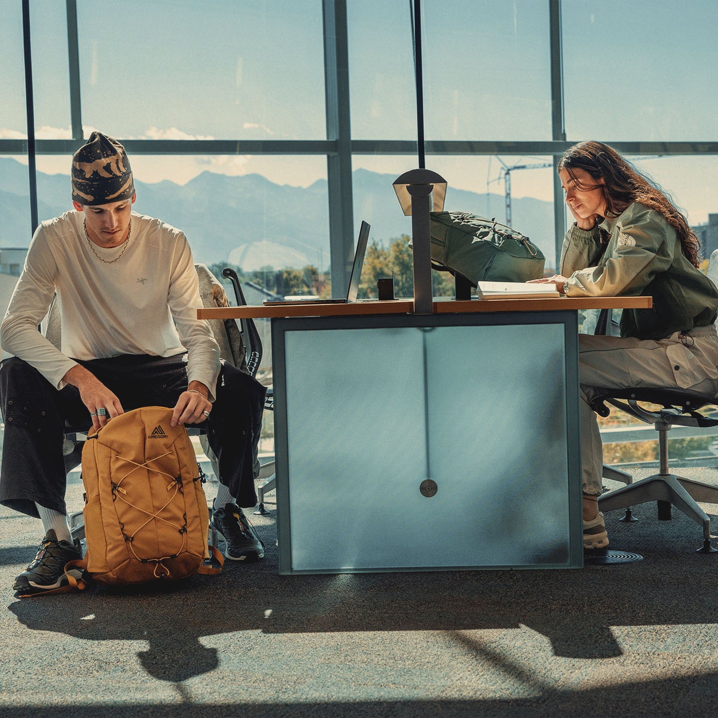 Two people sitting at a desk with their Terros packs doing work. 
